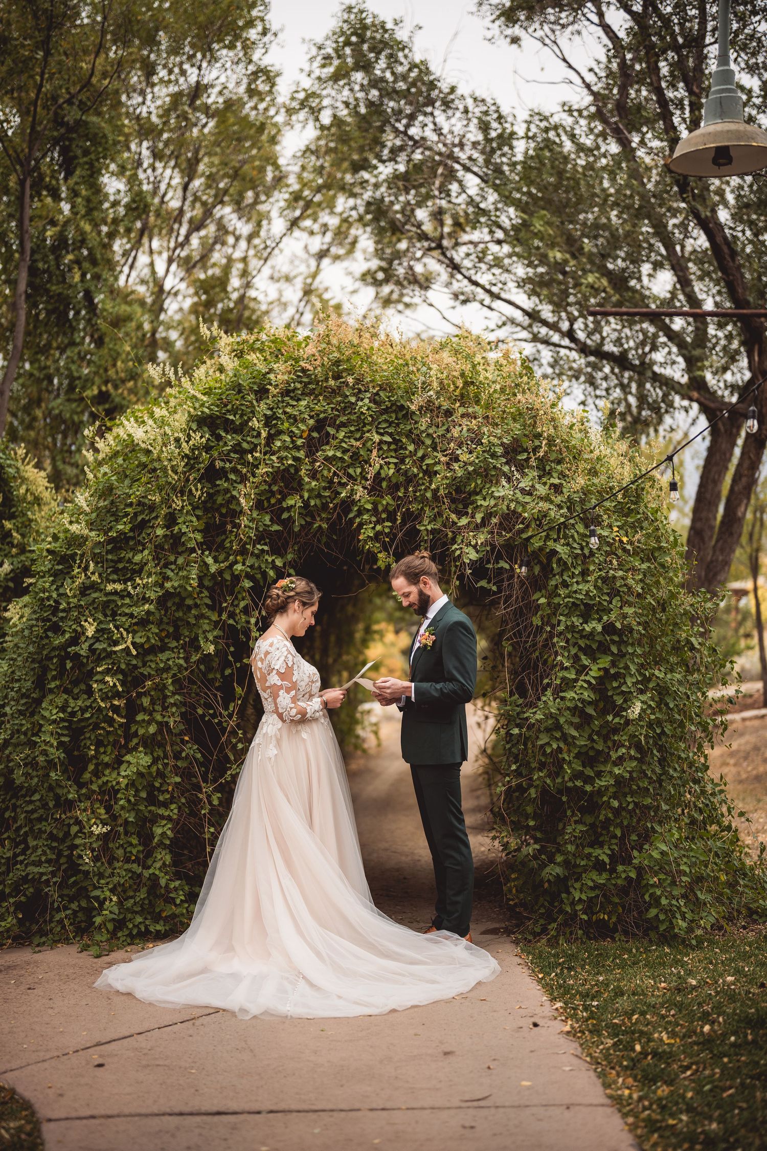 Romantic wedding ceremony moment captured on stone path with natural garden backdrop.