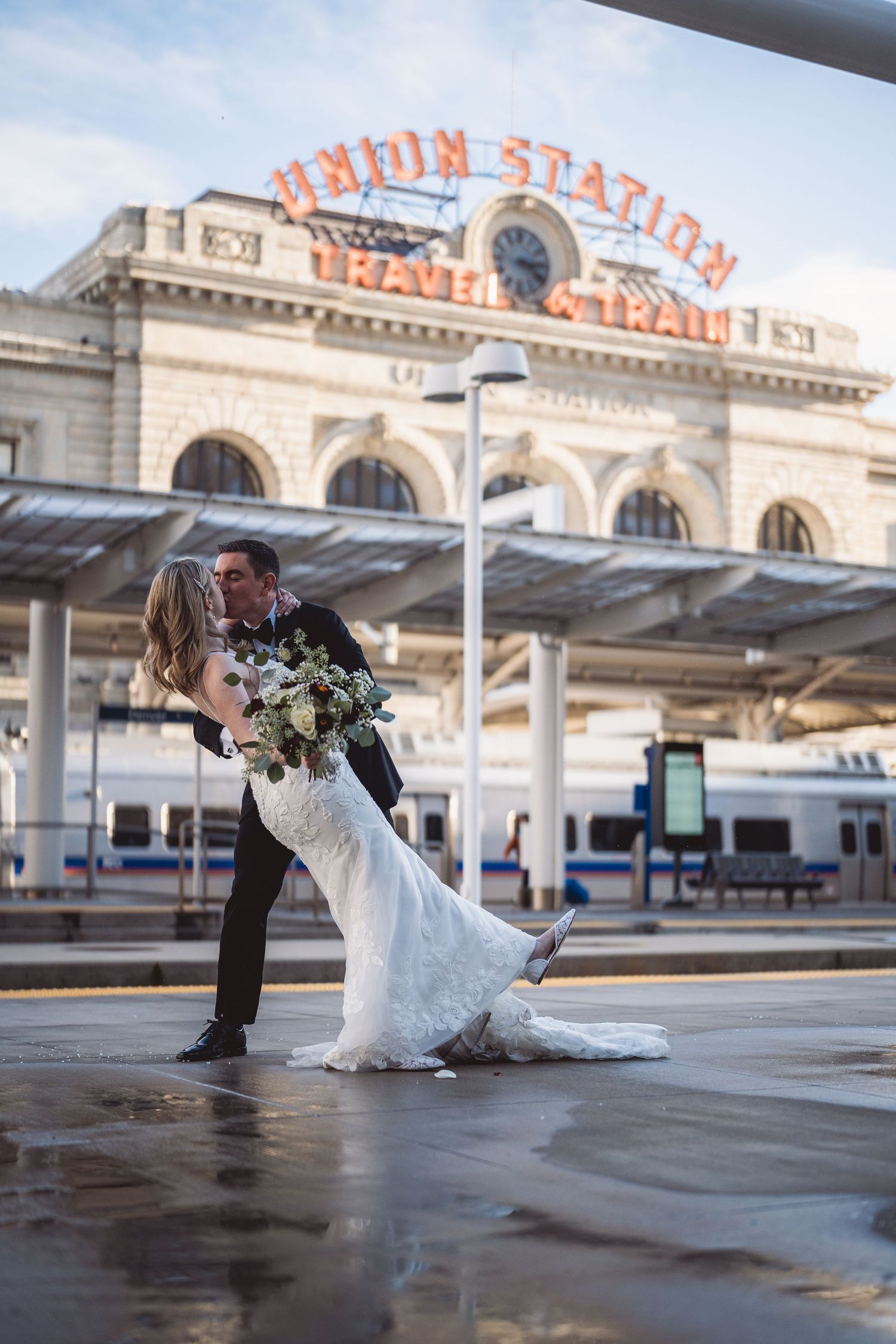 Wedding photos taken at Union Station with the iconic orange sign visible in the background.