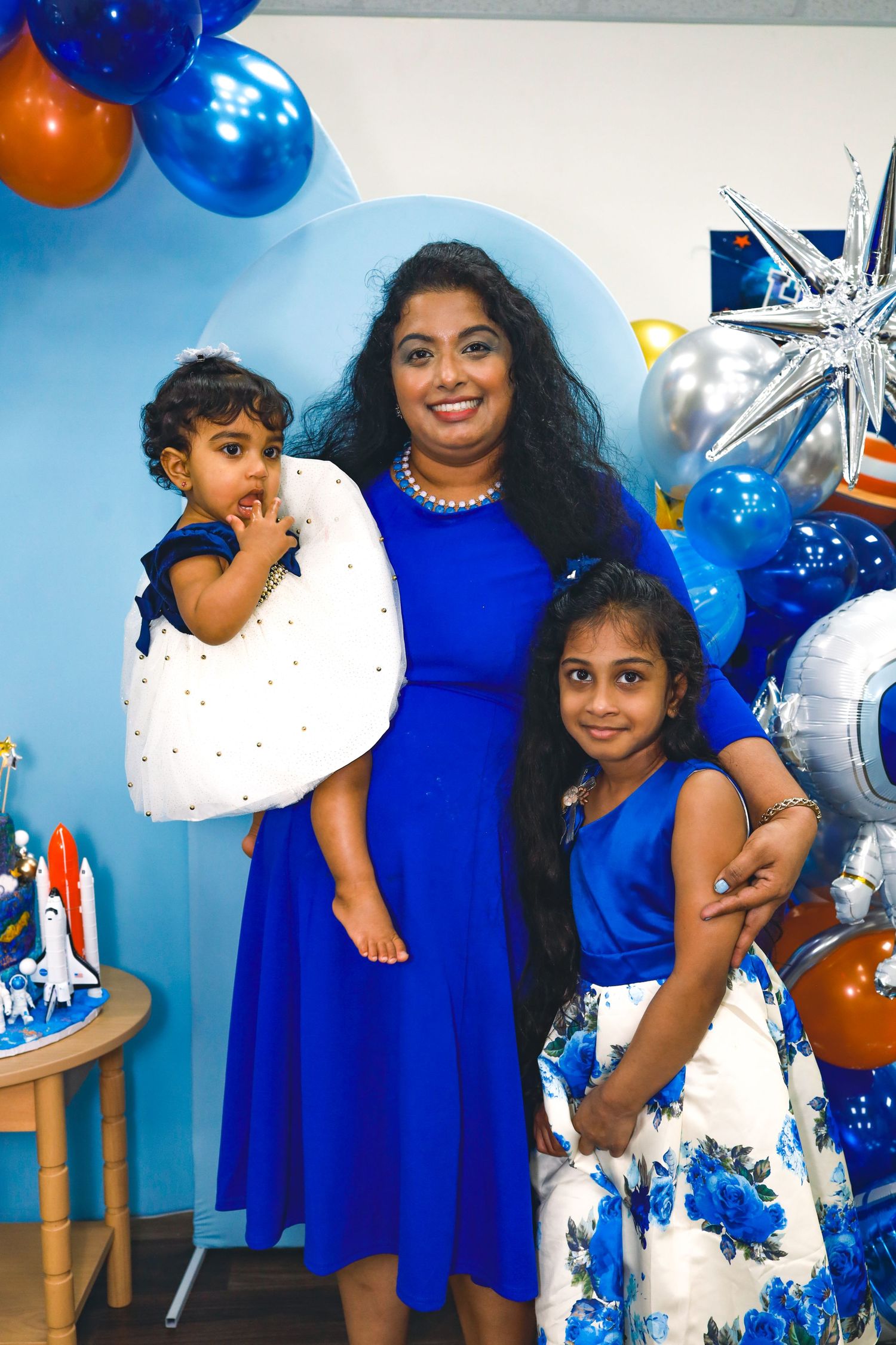two kids and mom posing