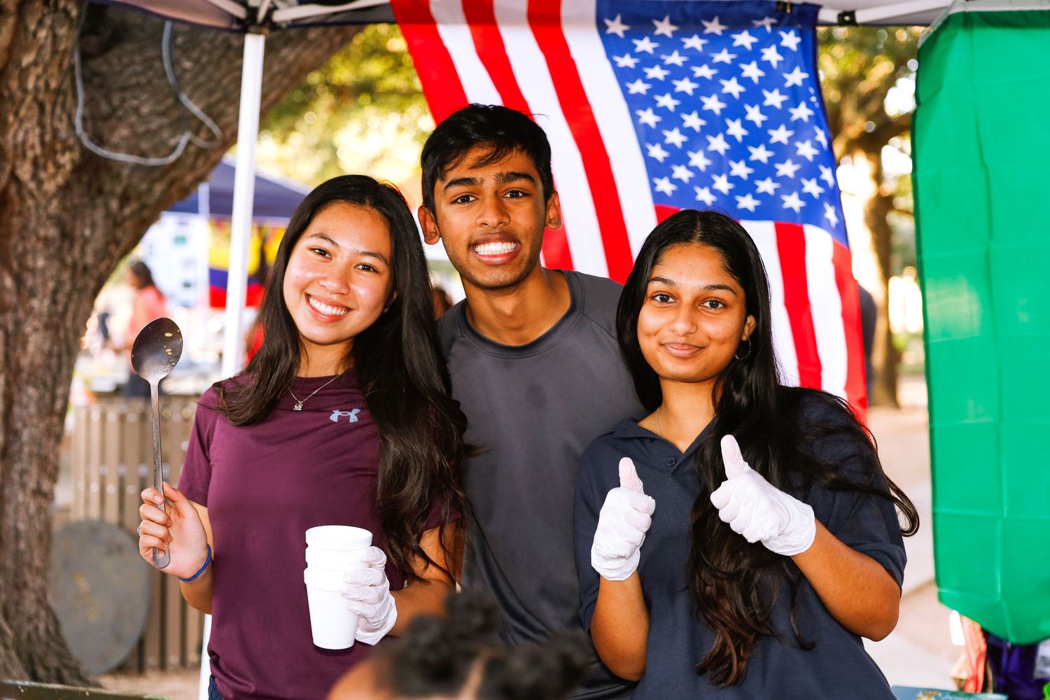 school international festival. country booth three people.