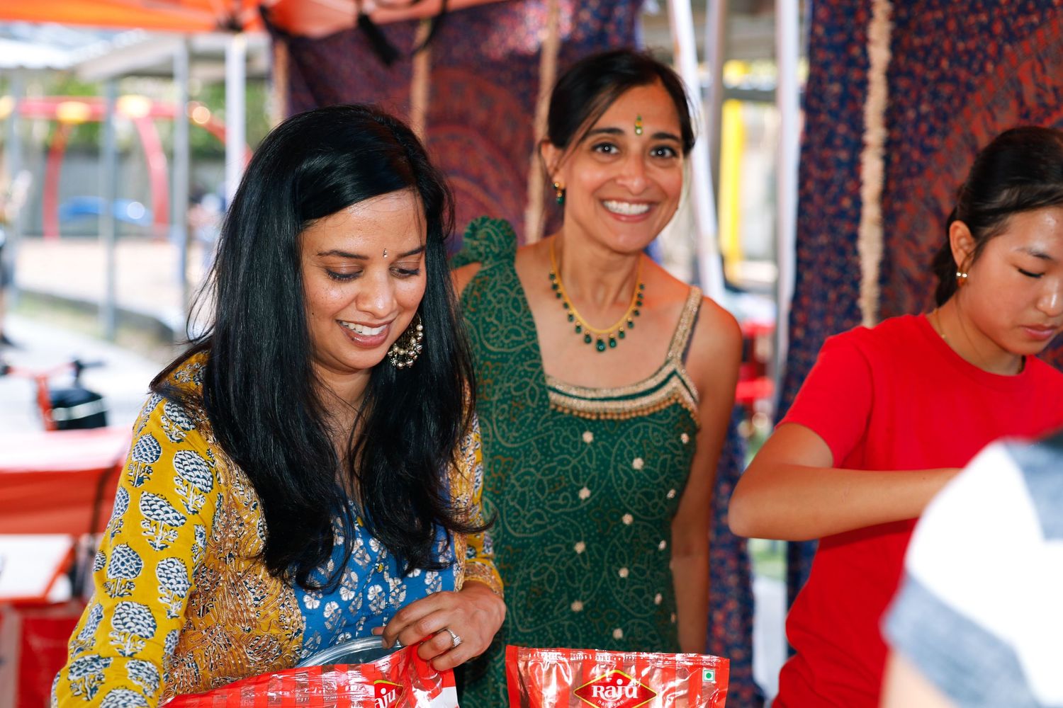school international festival. country booth three people.