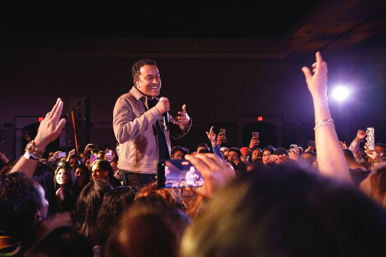 Musical show. A man singing. crowd cheering.