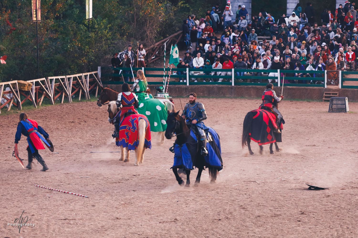 Renaissance style fighting act between men at a open arena. four horsemen and a man.