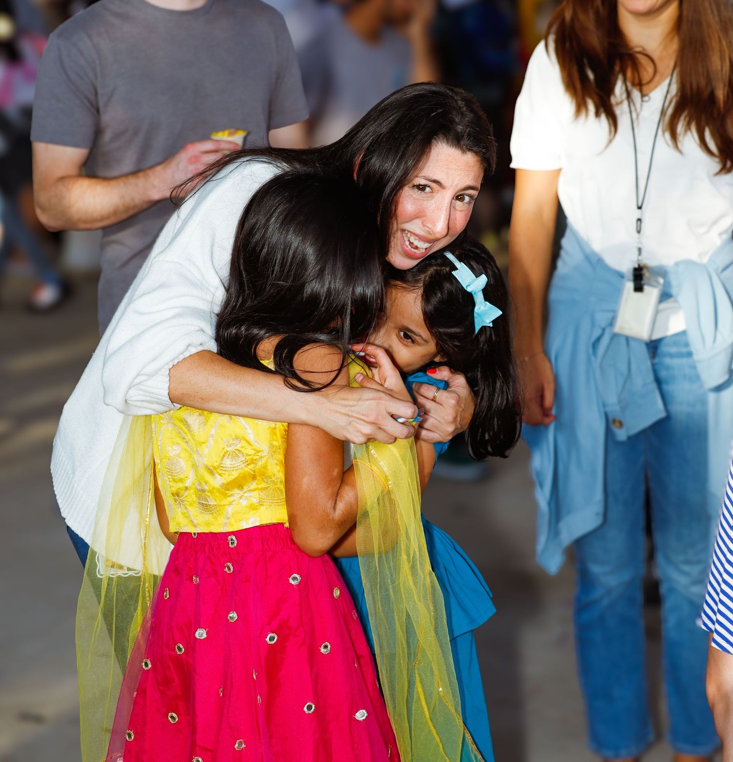 teacher hugging students.