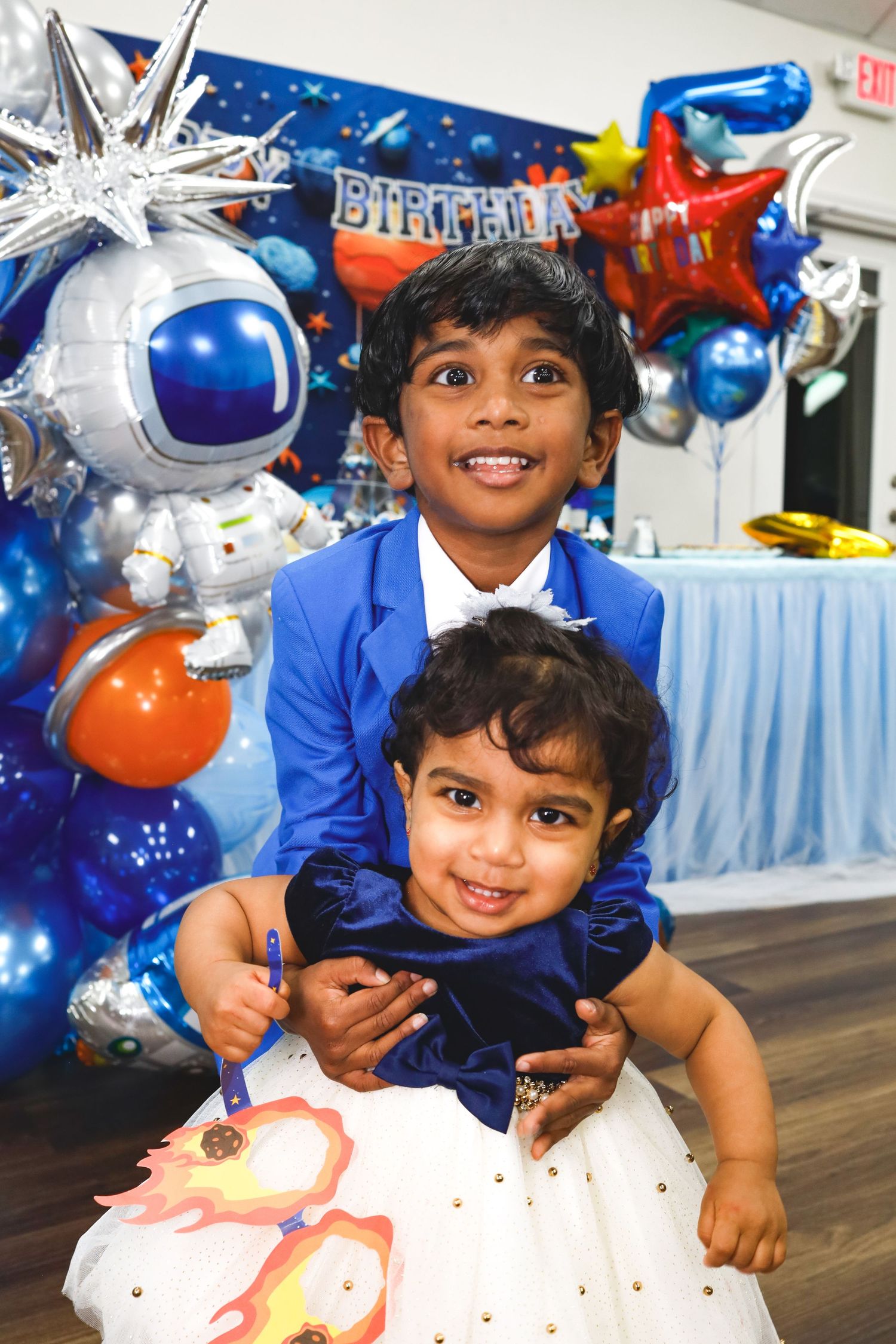 Two kids at a birthday party. blue decor