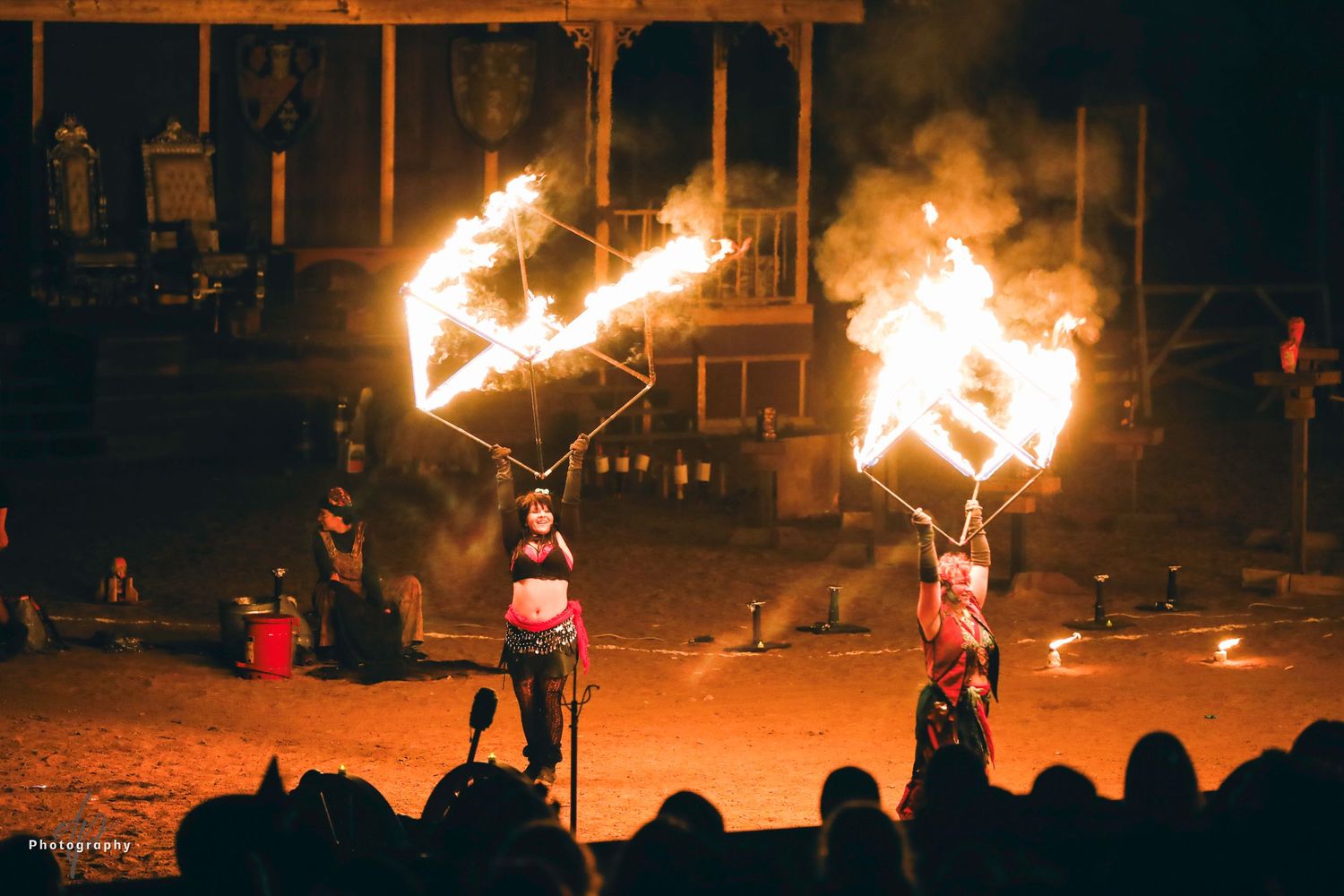 Two performers act with fire