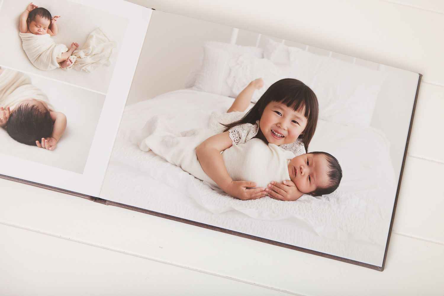 Artistic newborn photography layout with white backdrop and natural lighting.