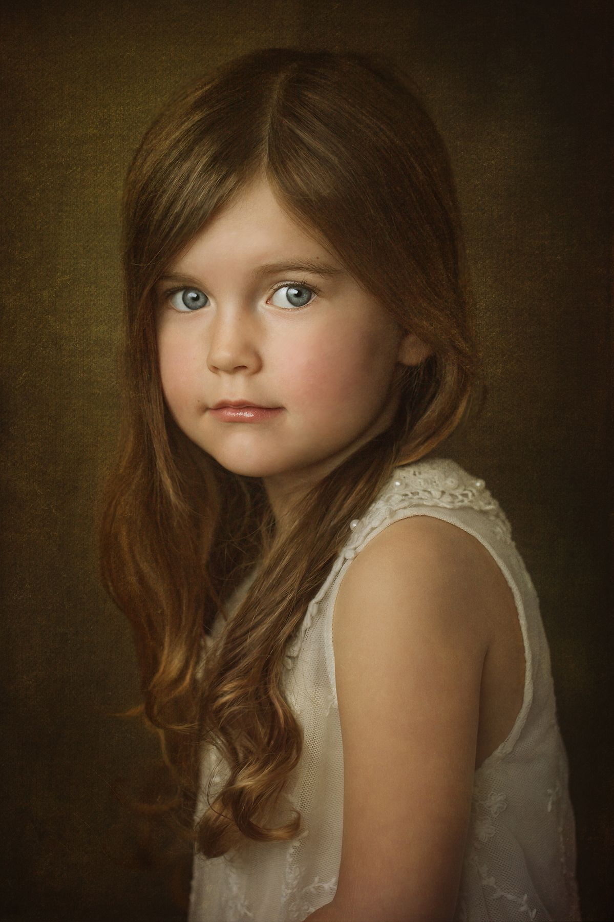 Ethereal portrait with soft lighting highlighting delicate lace details and flowing hair.