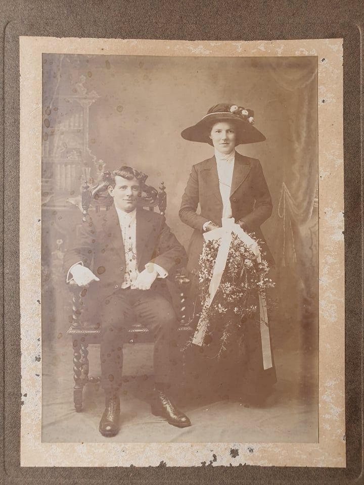 Vintage sepia photograph showing people in Victorian-era clothing and hats.