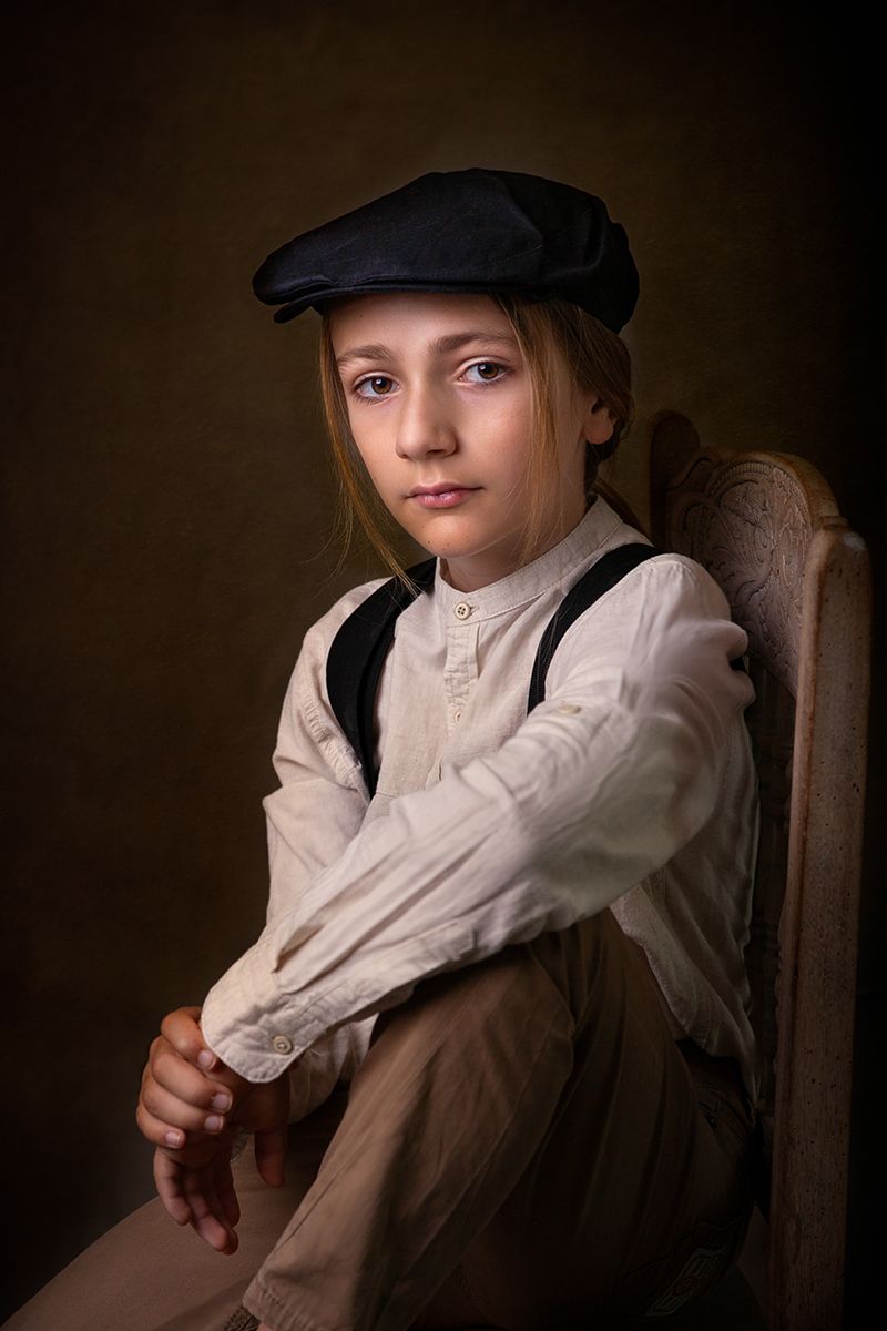 Portrait series in dark tones featuring vintage-style clothing and cap.