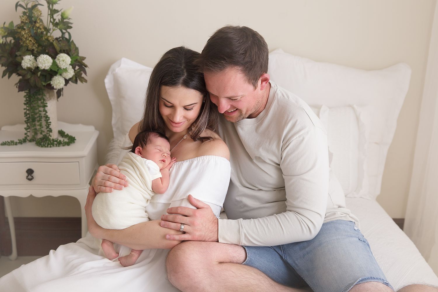 Family portrait session featuring natural poses and greenery accents.