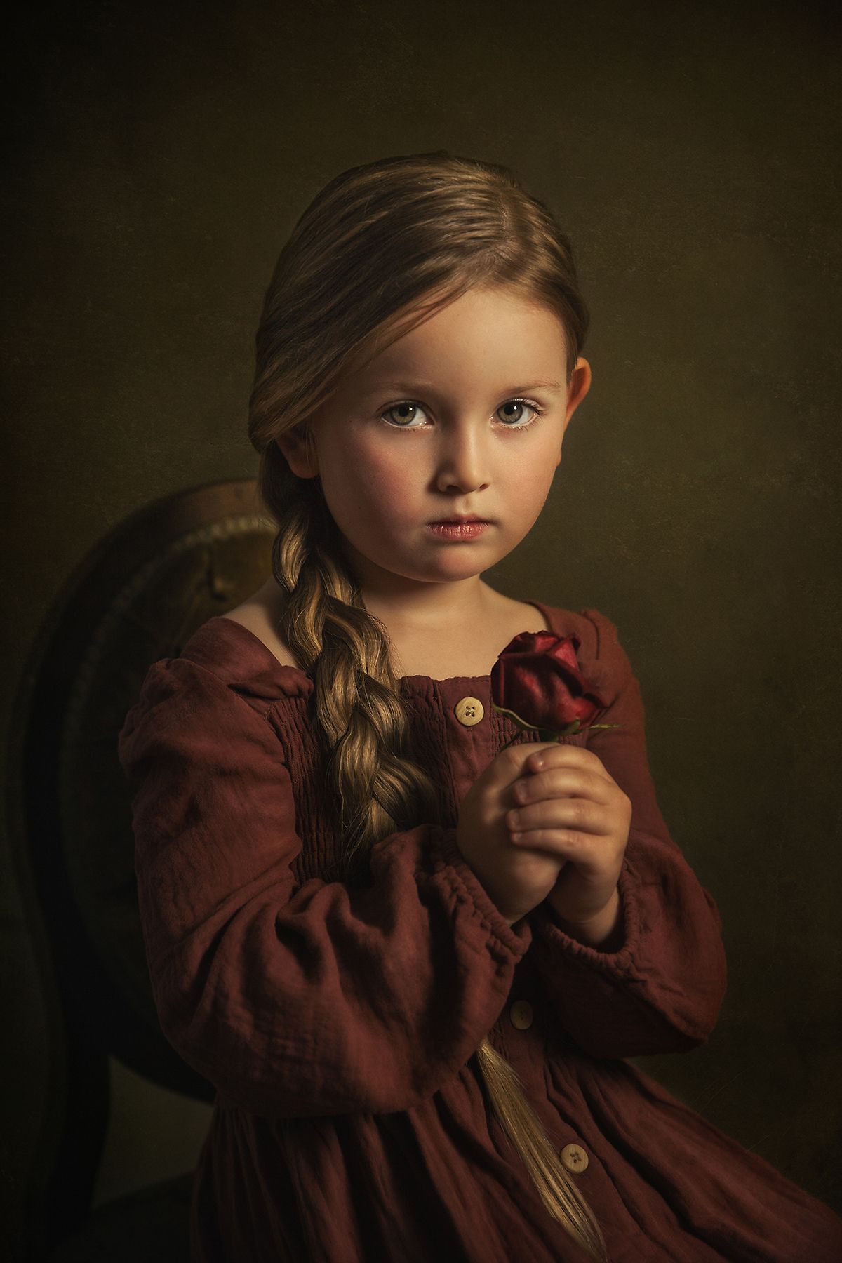 Dramatic portrait in burgundy tones showing vintage-inspired styling.