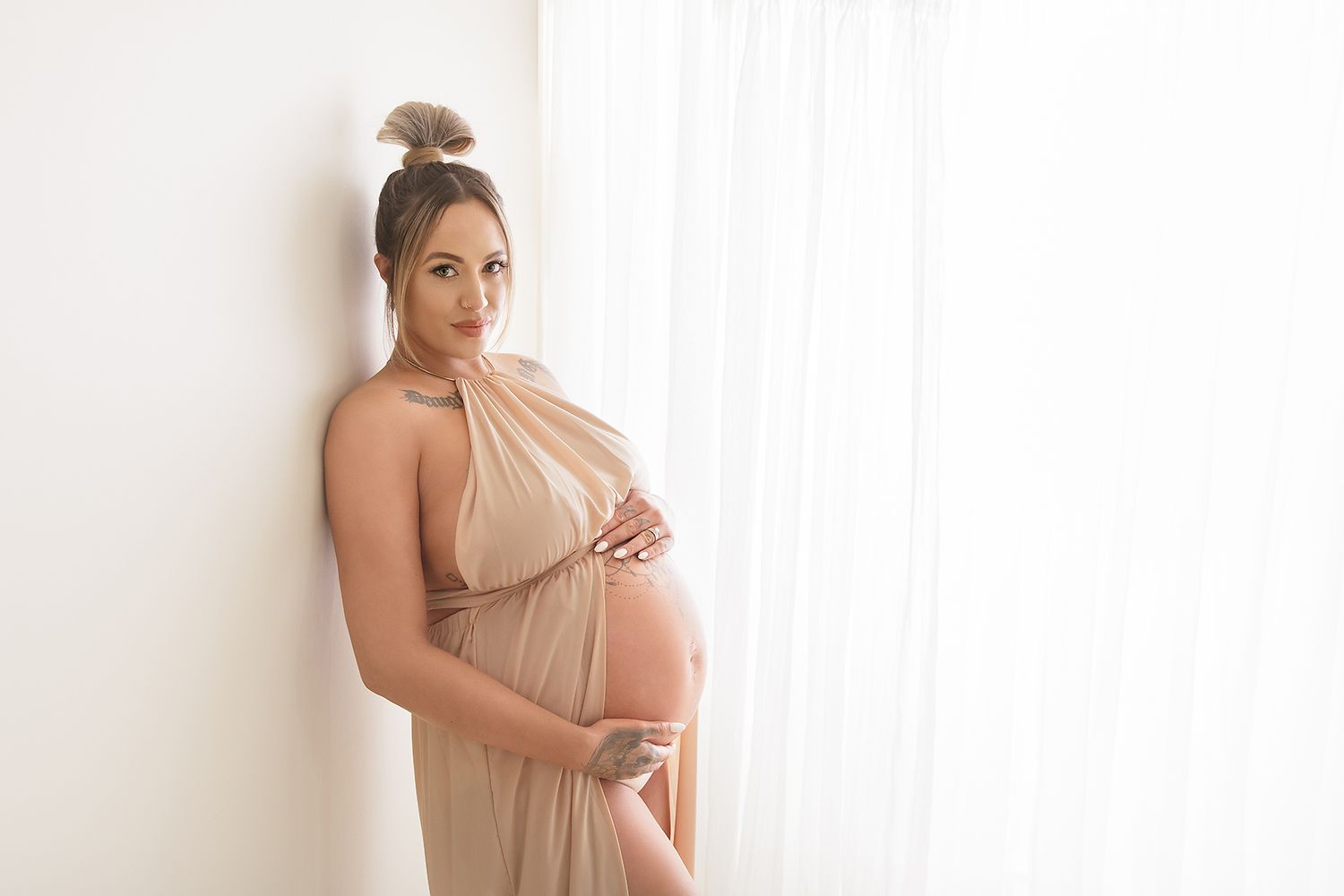 Artistic maternity portraits in neutral tones showcasing the beauty of pregnancy.