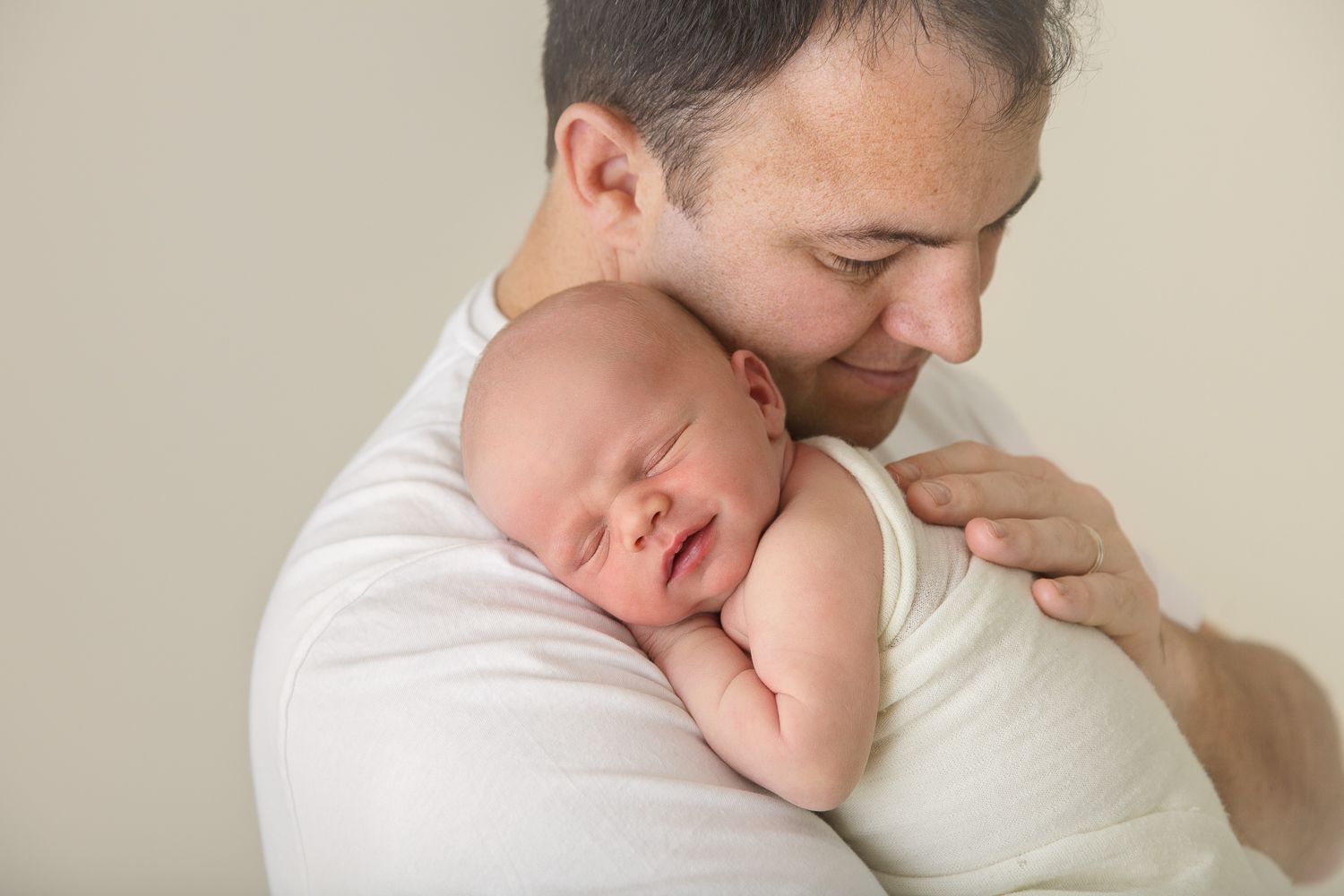 Intimate newborn photography session with soft natural lighting.