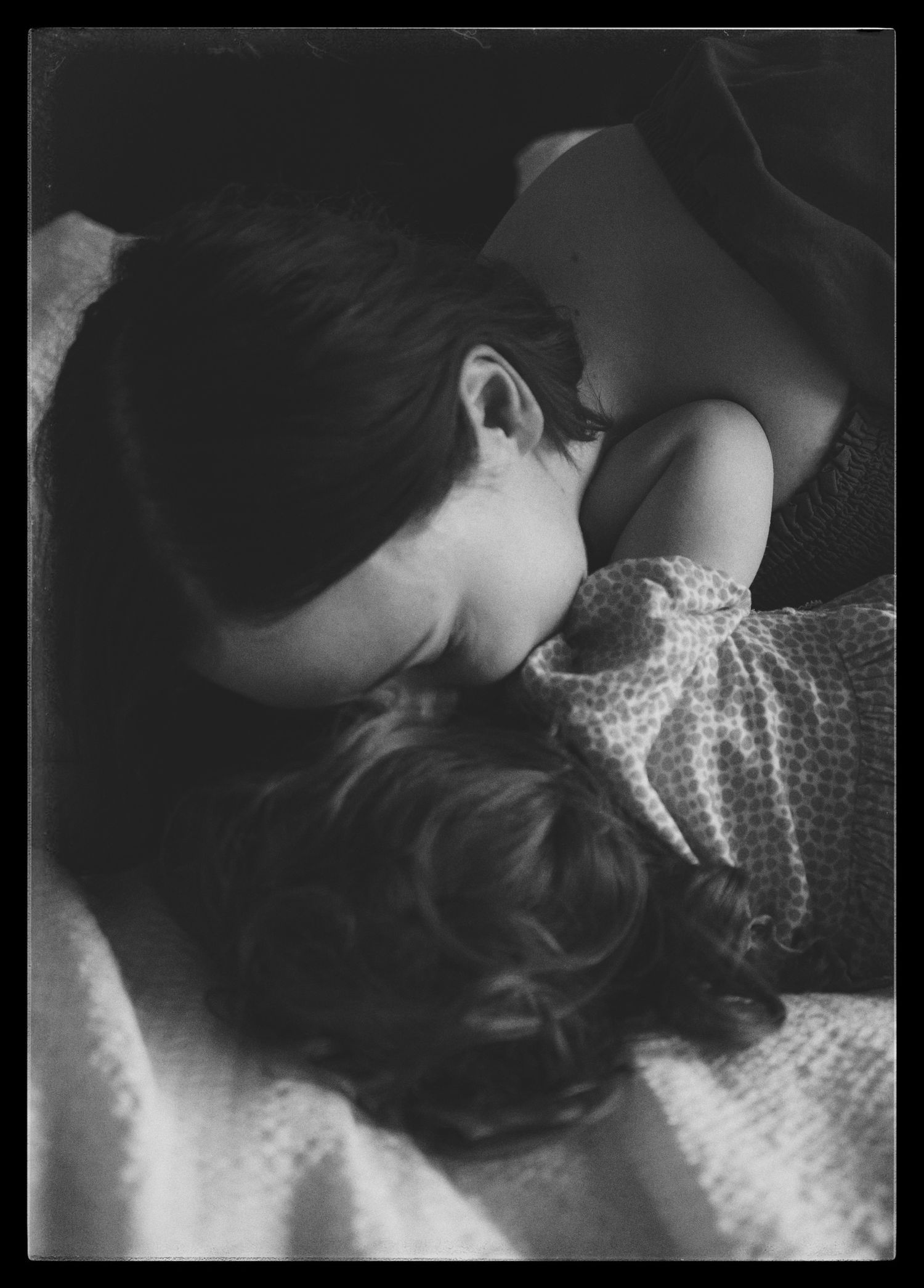 Artistic black and white photograph showing emotional connection with delicate fabric textures.