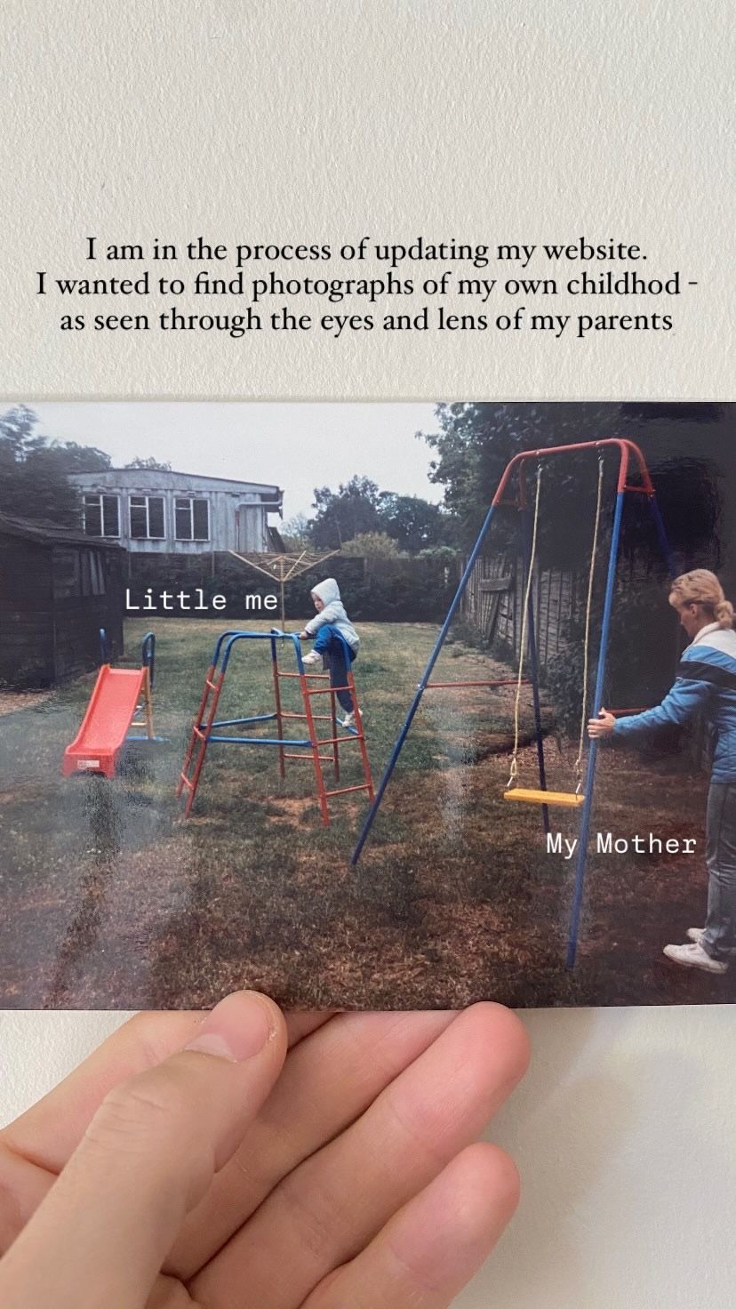 A vintage photograph of a backyard playground with a red slide and swing set on a cloudy day.