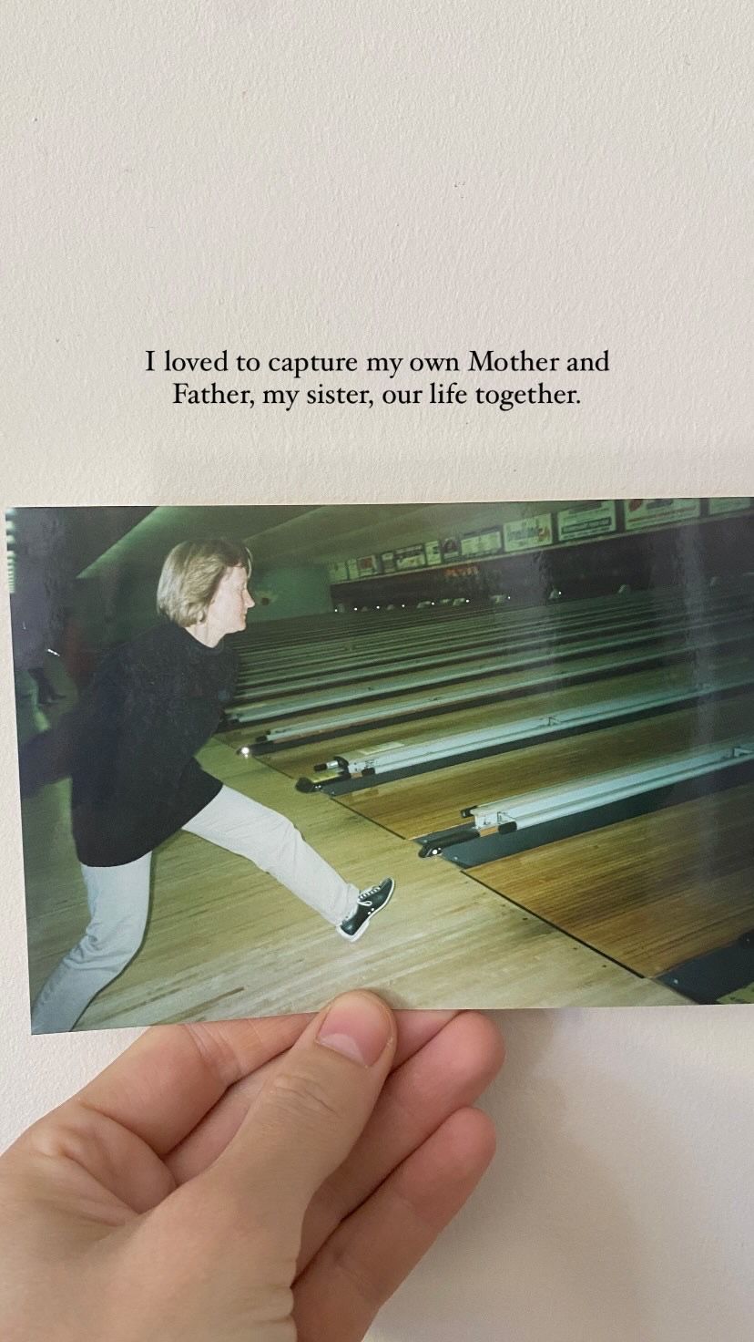 Vintage photograph shows a person bowling at a retro bowling alley with wooden lanes.