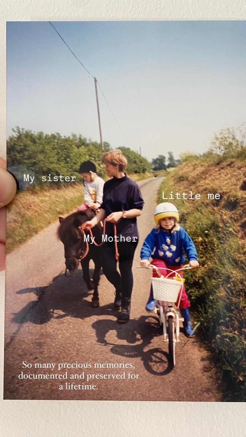 A group walks along a dirt path in the countryside while enjoying a sunny day outdoors together.