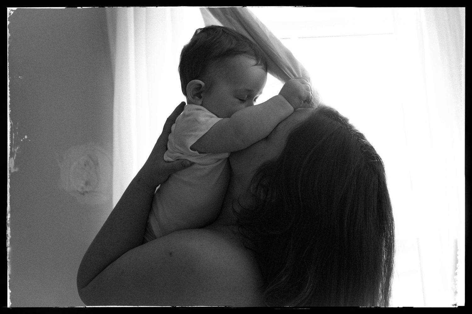 Intimate black and white portrait showing closeness and connection in natural light.