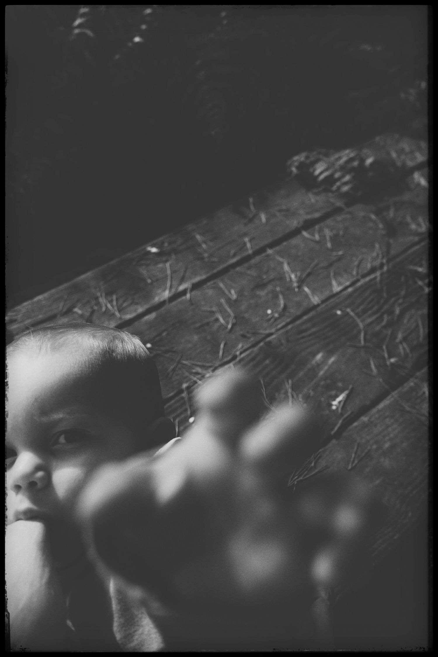 Abstract black and white photograph with dramatic shadows and textures.