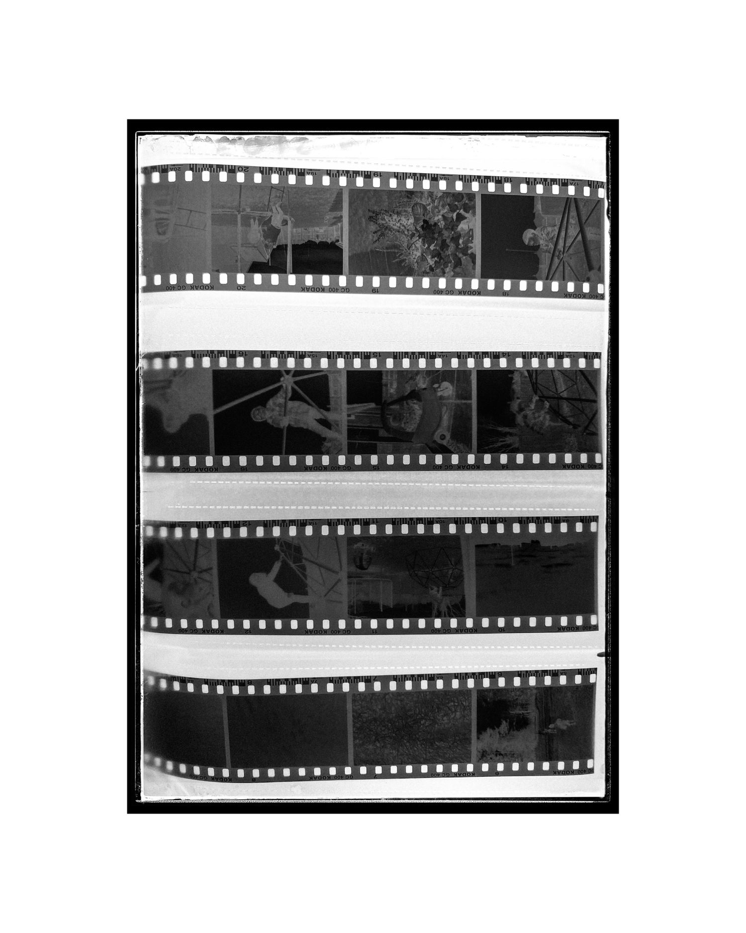 Contact sheet of black and white film strips showing multiple frames of photography.