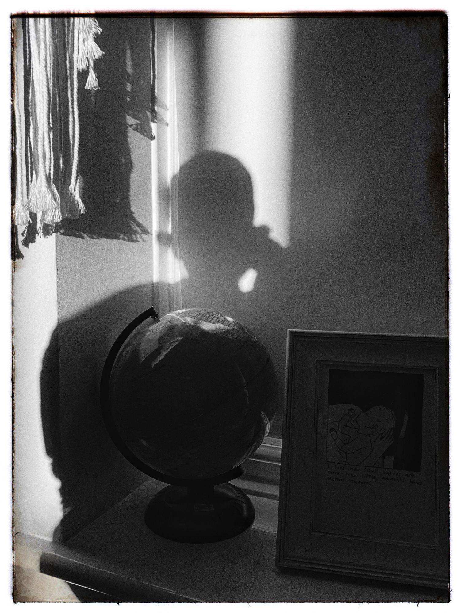 Dark silhouettes against a window with dramatic lighting and shadows.