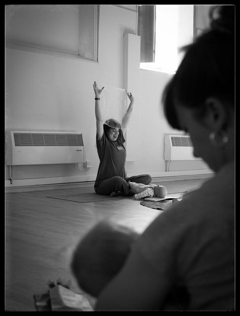 A sequence showing people laying on a studio floor during a contemporary dance or movement workshop in black and white.