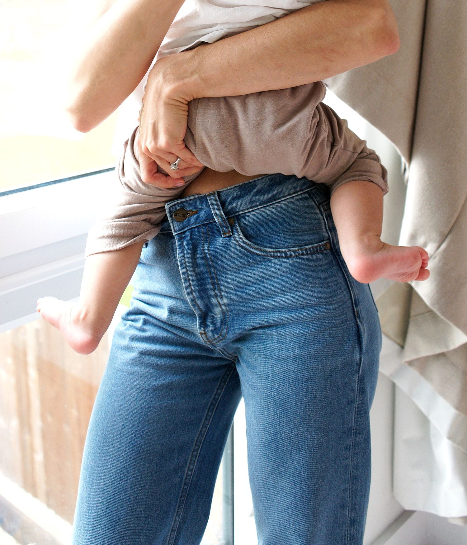 Close-up series of blue jeans and white top outfit details.