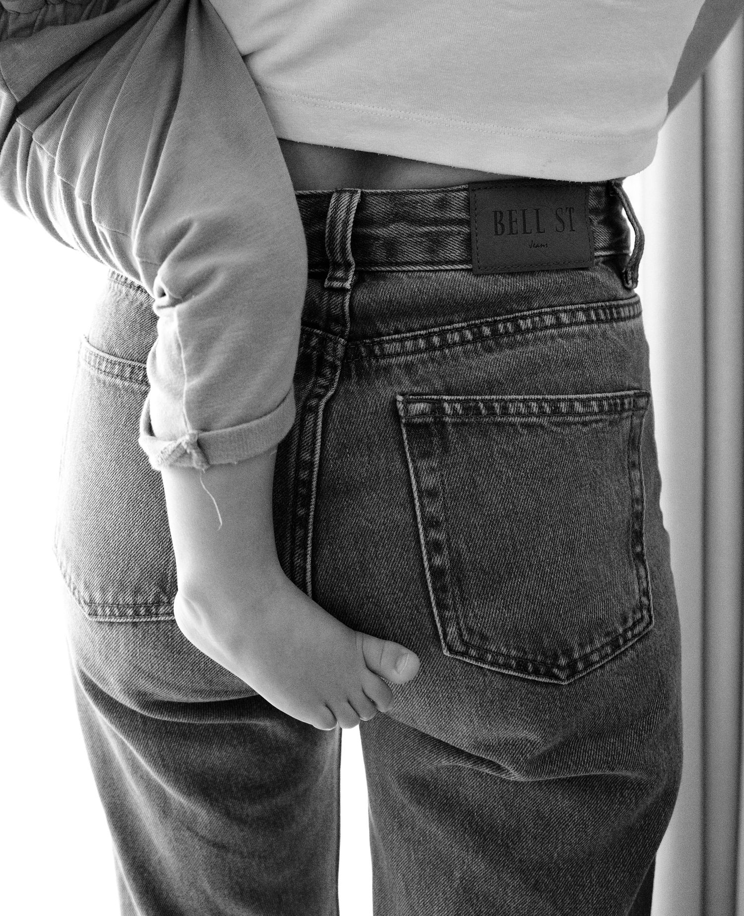 Close-up view of back pockets on classic blue denim jeans shown from different angles.