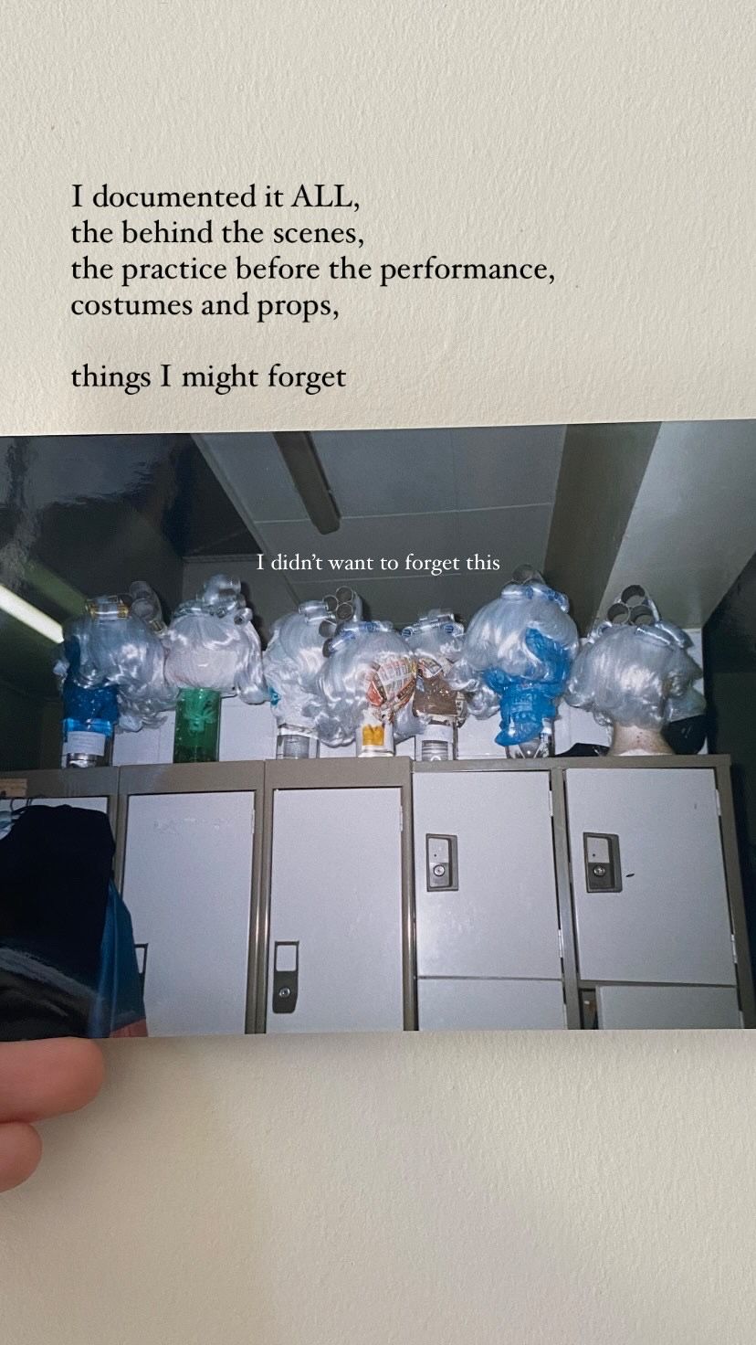 White bathroom cabinets lined with plastic storage containers and props organized for a theatrical performance.