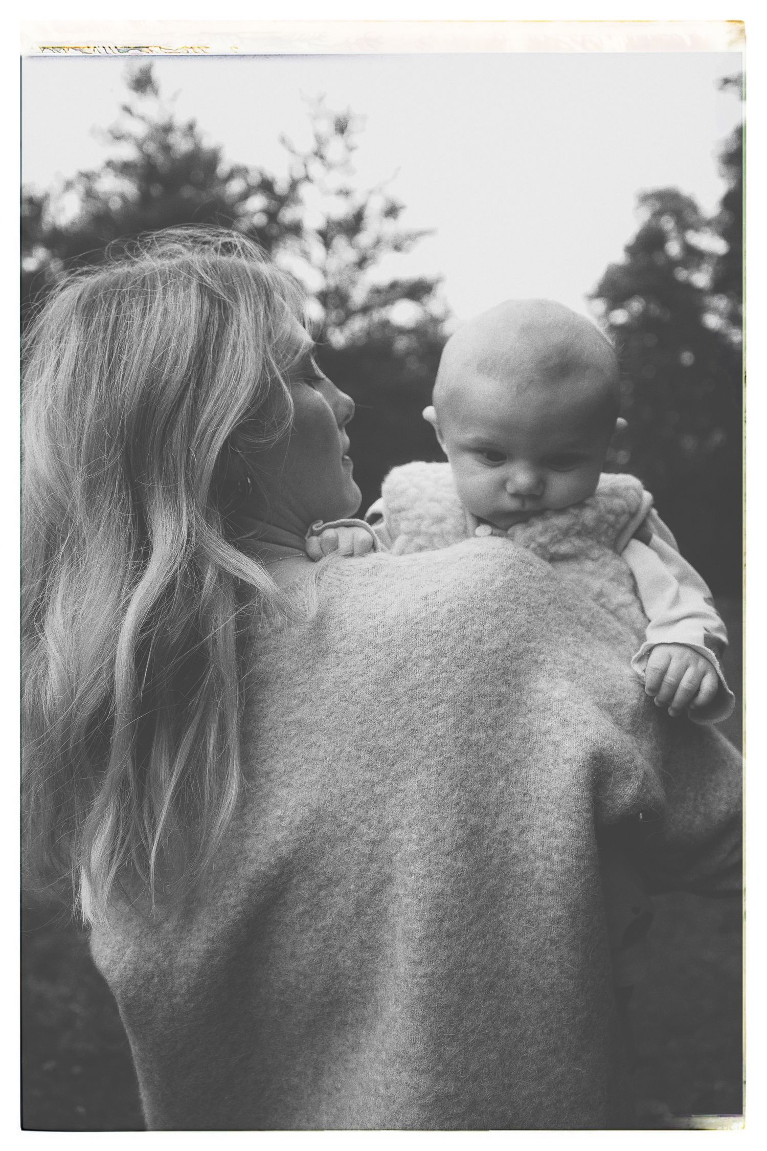 Black and white photograph series showing close up profile of person carrying infant against blurry outdoor backdrop.