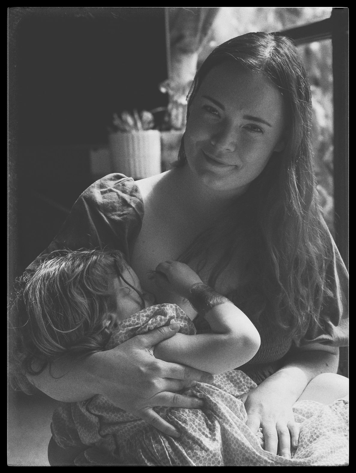 Candid moment captured in soft natural lighting showing joy and connection.