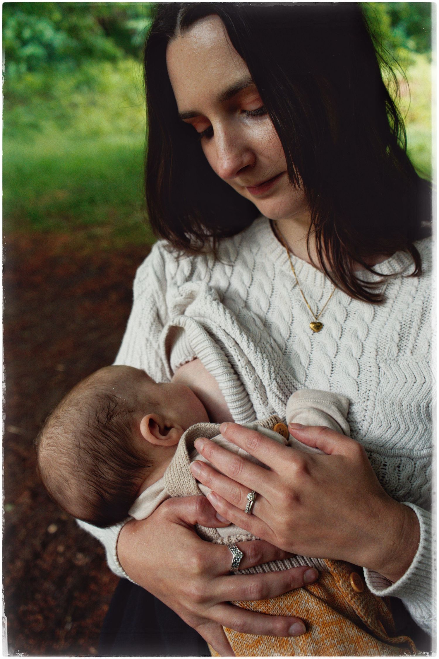 Intimate color portrait showing tender moment of care in natural outdoor setting.