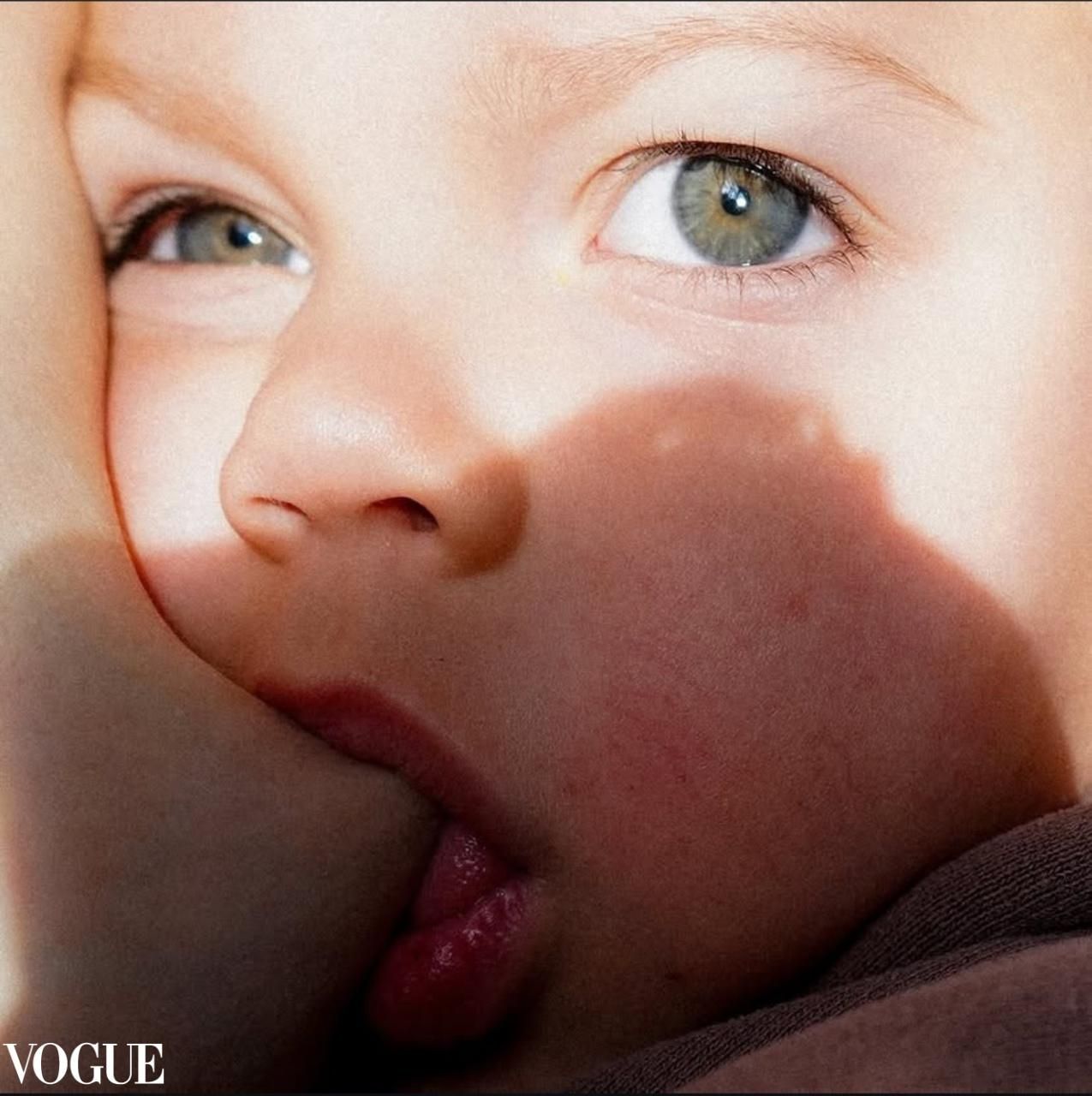 Extreme close-up of child's eye and partial face with shadow cast across features.