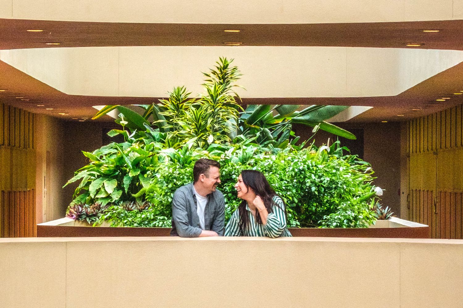 a happy couple recently engaged on a balcony at the marin county civic center
