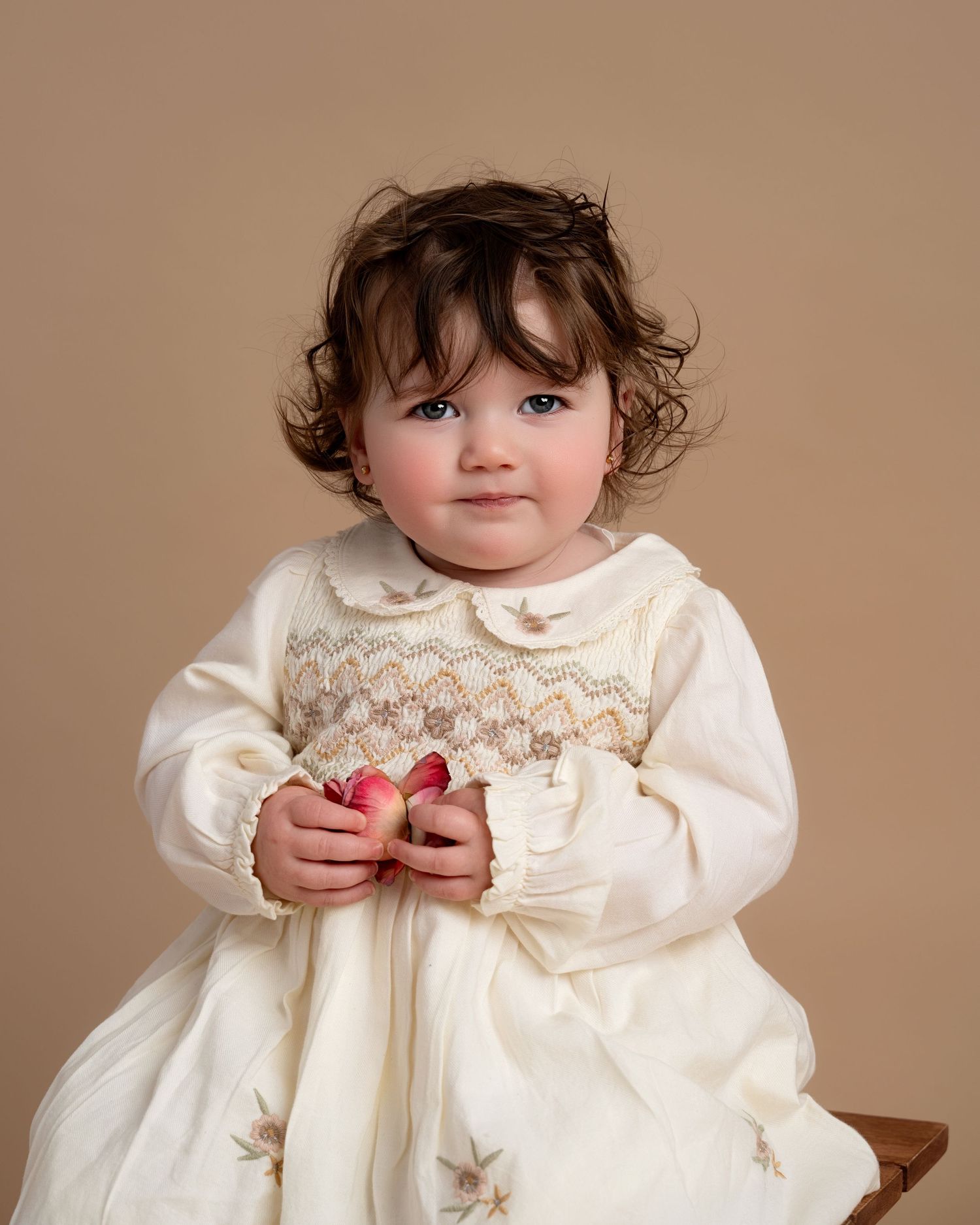 Mother holding toddler daughter during a natural studio family photography session in Lancashire
