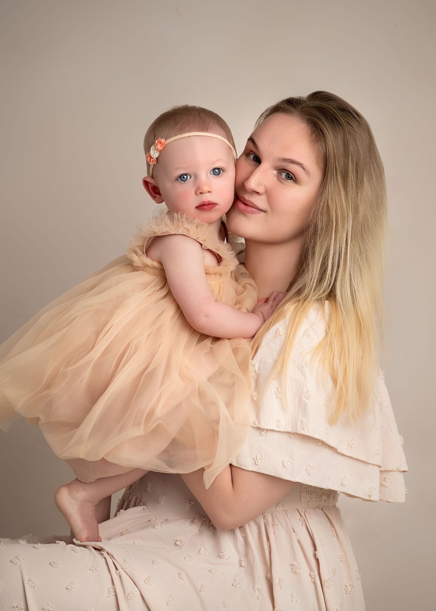 Mother holding baby in studio