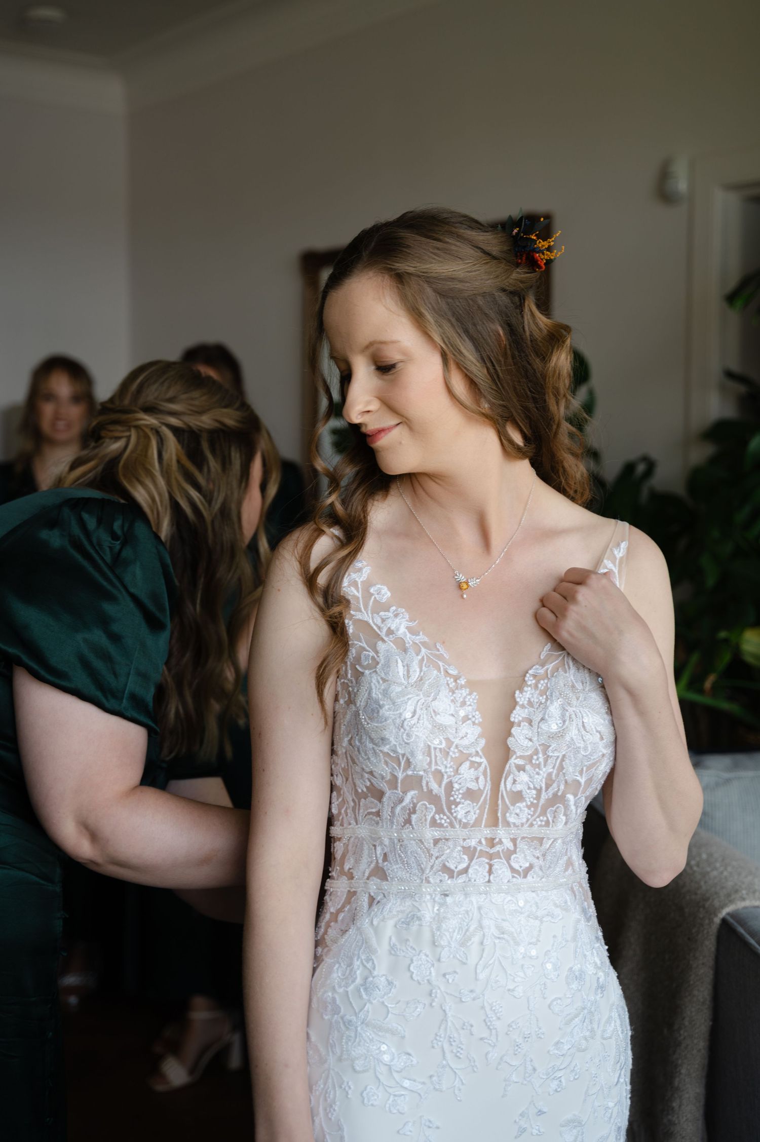 Bride smiling and looking to the side as she gets ready for her wedding