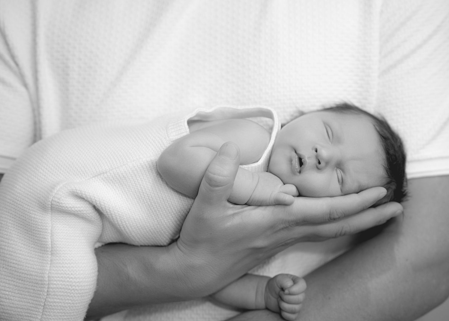 Newborn resting peacefully on a soft blanket