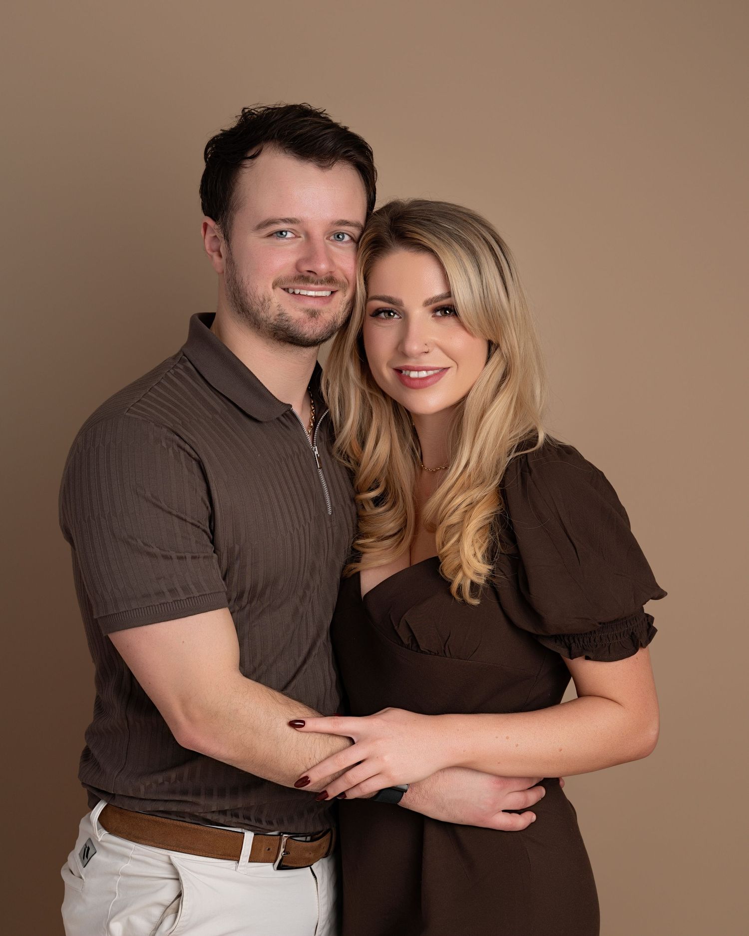 Family portrait during a studio family photoshoot in Lancashire with parents and three young children wearing neutral coordinated outfits