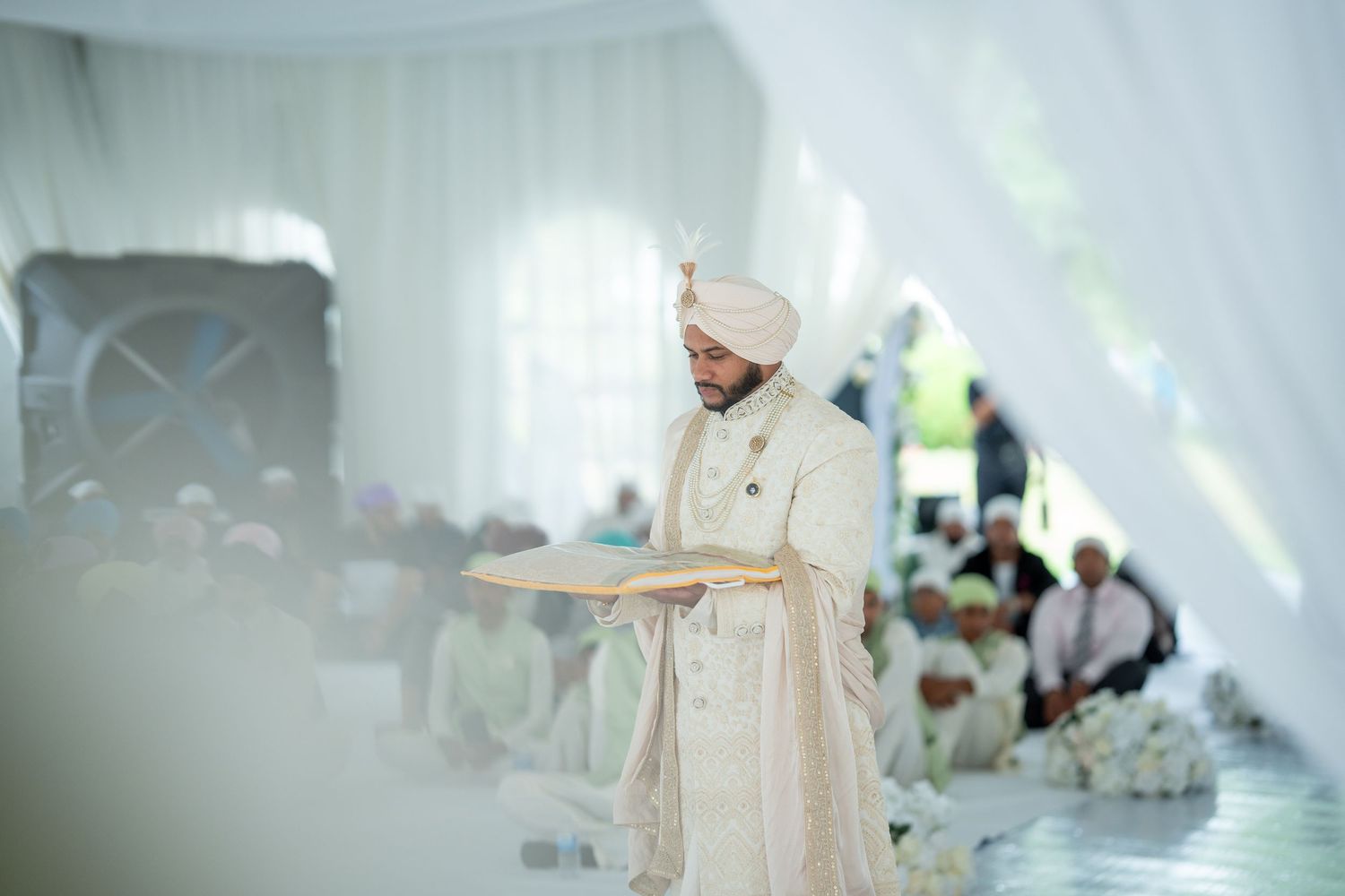Elegant white wedding tent interior with flowing drapes and soft lighting for an intimate ceremony.