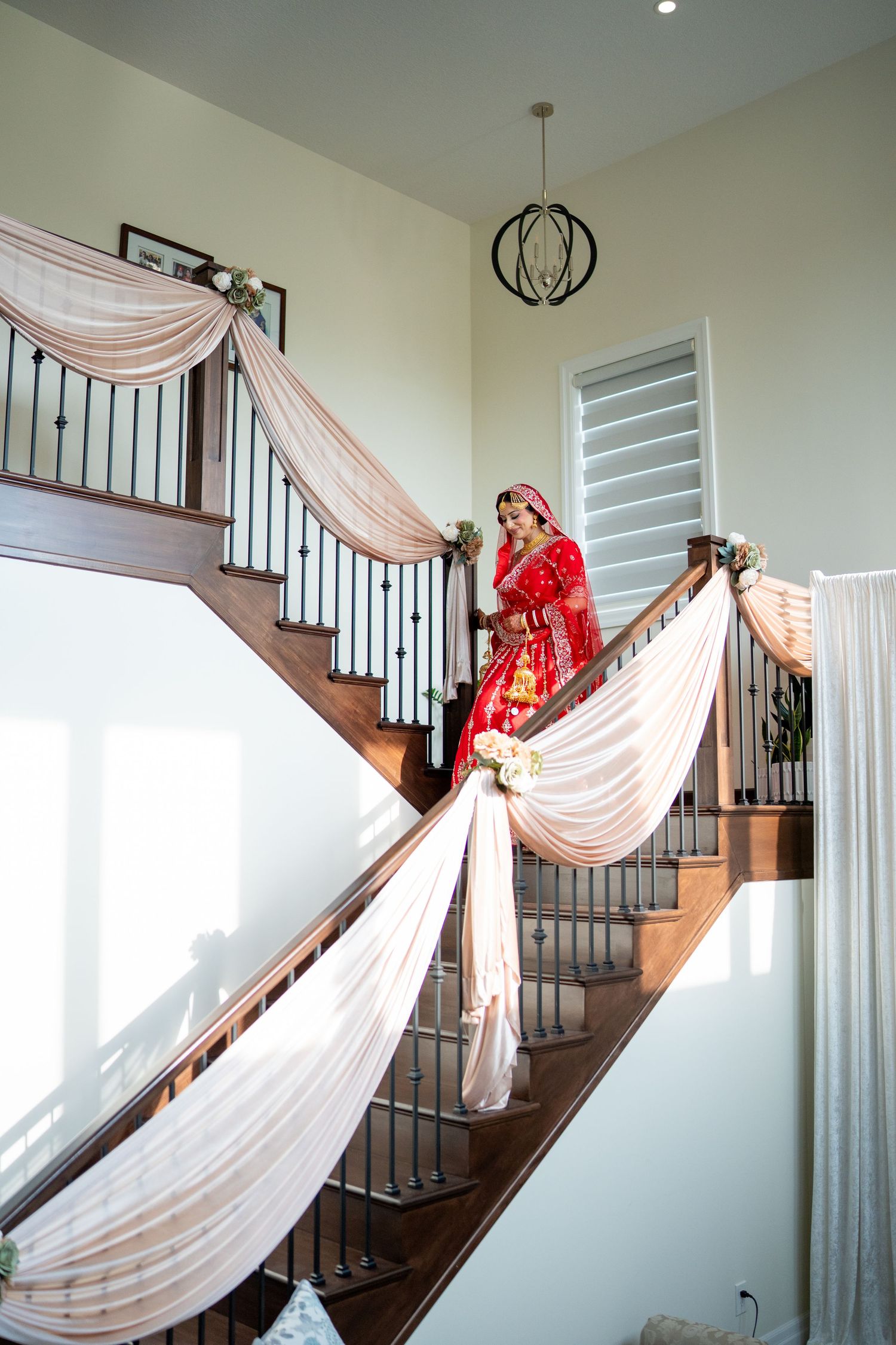 White fabric drapes elegantly along a staircase railing creating a romantic wedding photography backdrop.