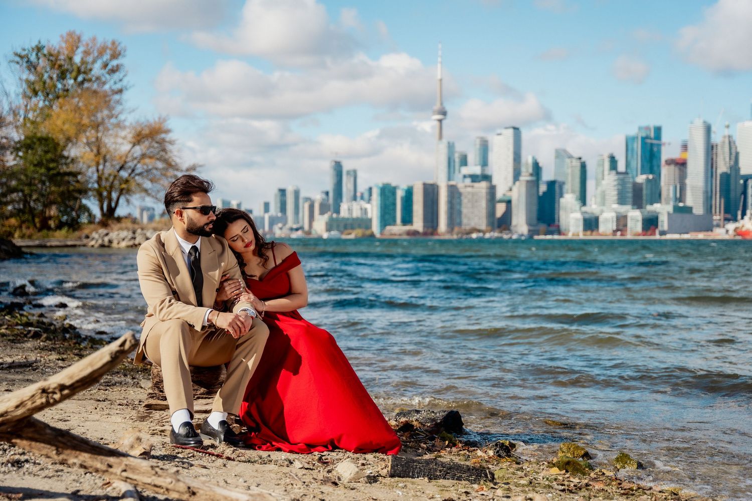 Romantic couple photoshoot along Toronto's waterfront with CN Tower and city skyline in the background.