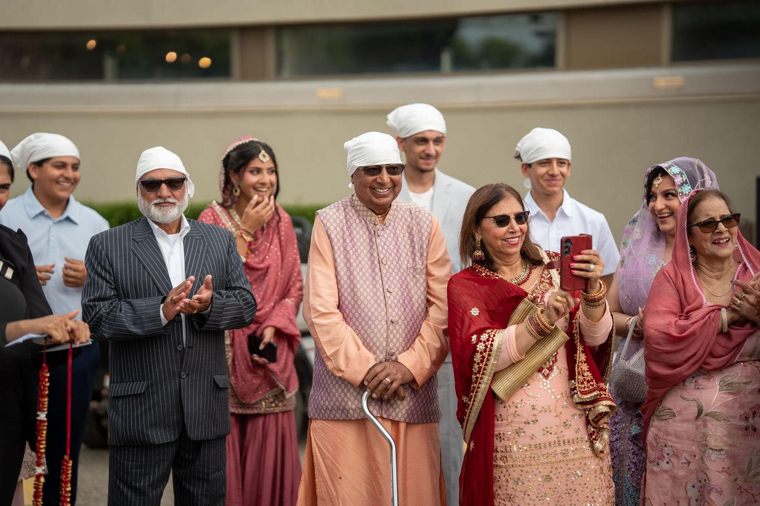 A group of guests in traditional South Asian attire gather at a cultural celebration event.