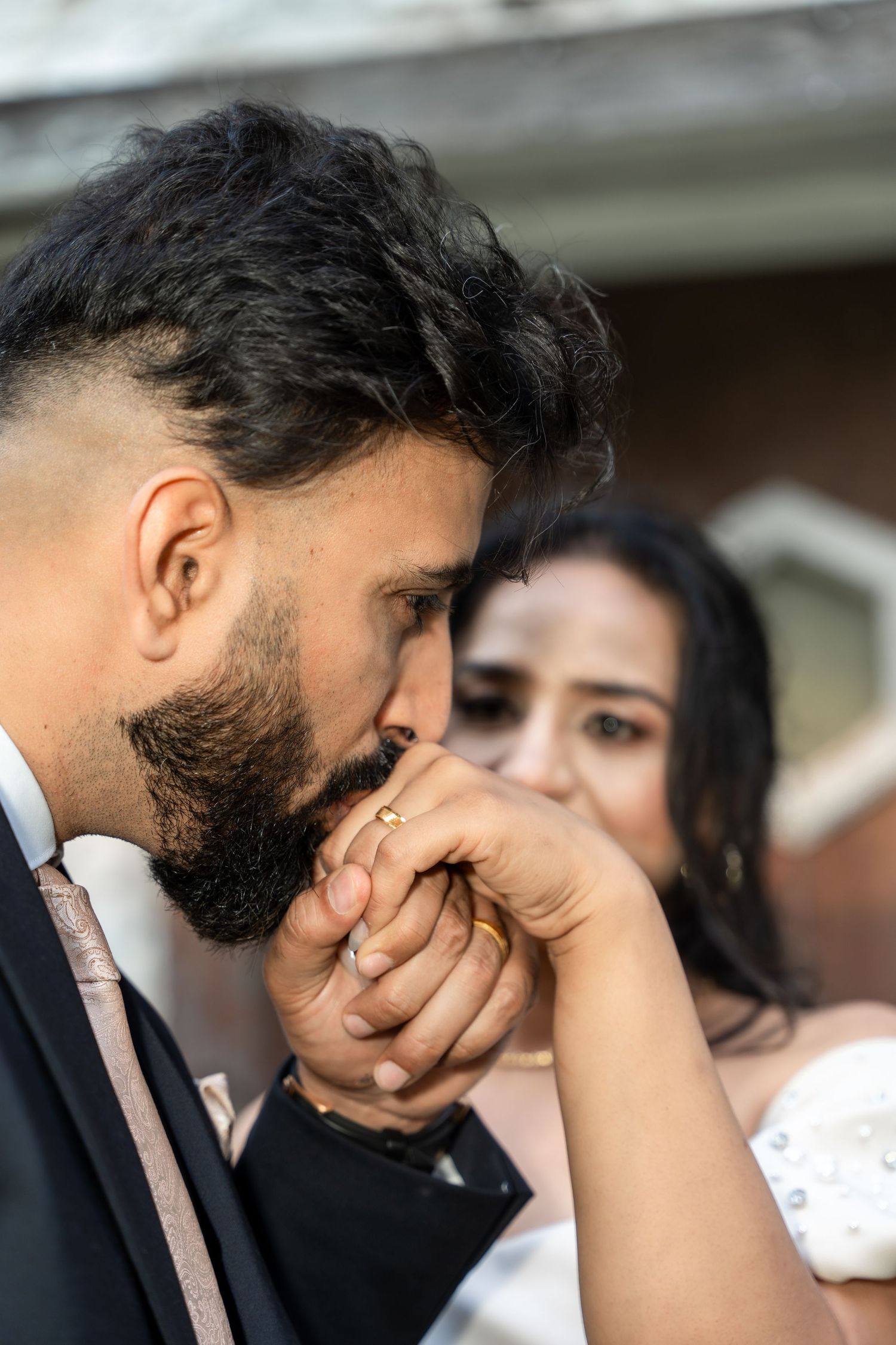 A sequence of photos showing a person in a suit reacting emotionally with their hand covering their face.