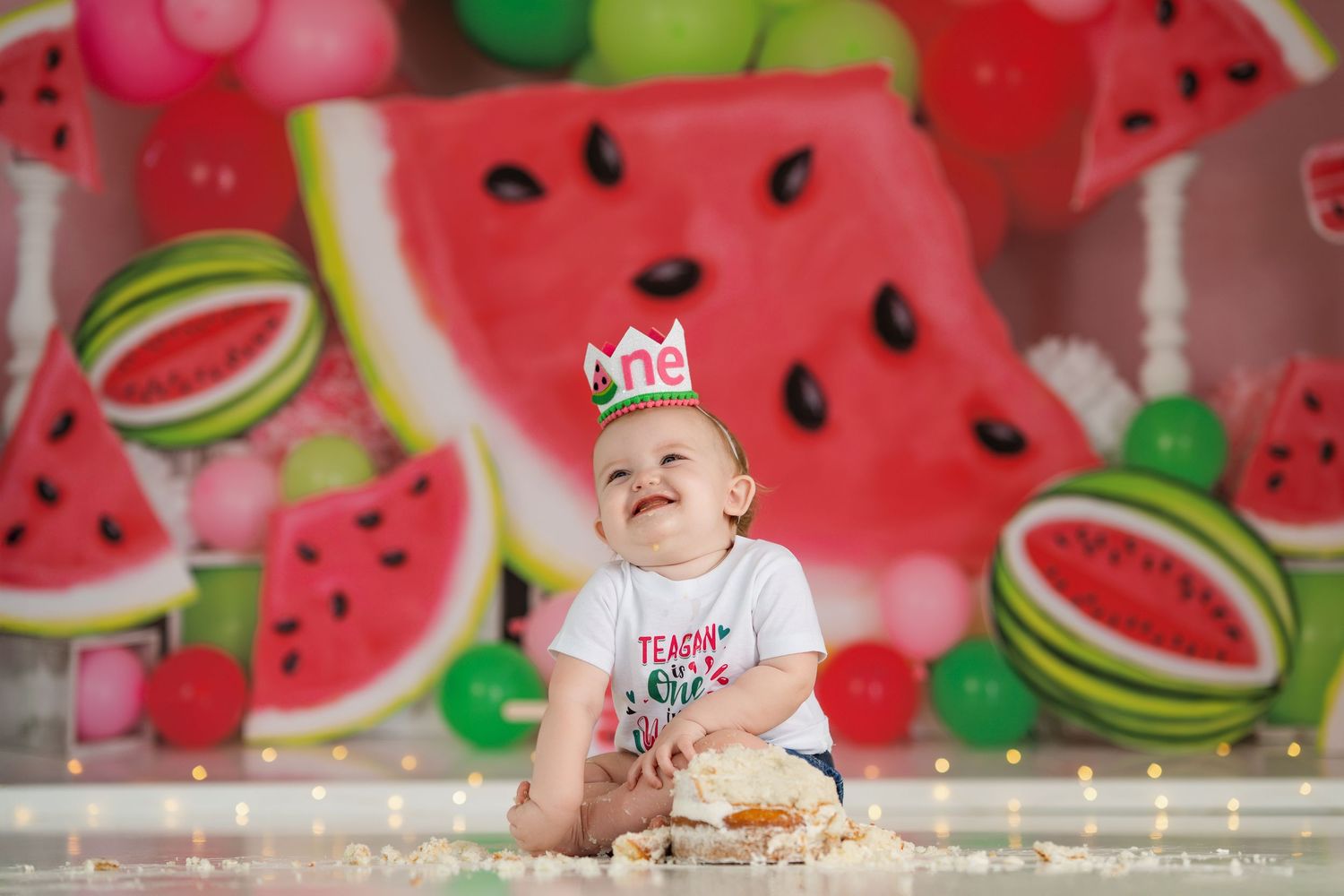 Party scene with watermelon decorations against a bright red background with string lights.