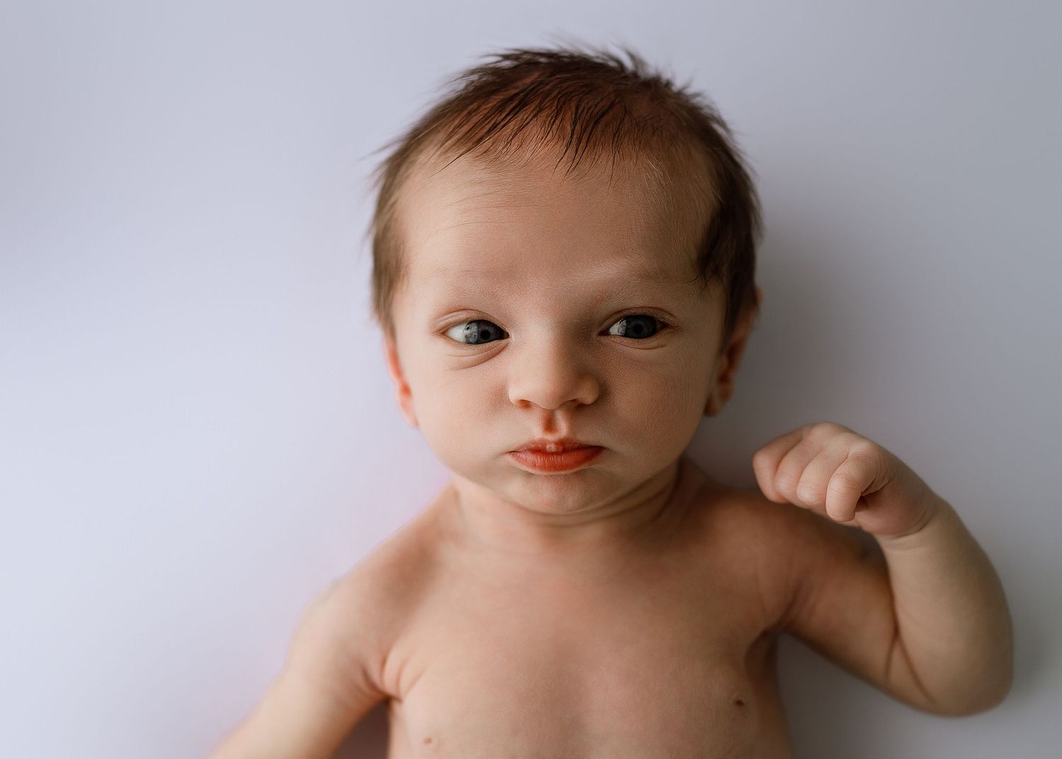 Simple portrait series of baby against white background showing various expressions.
