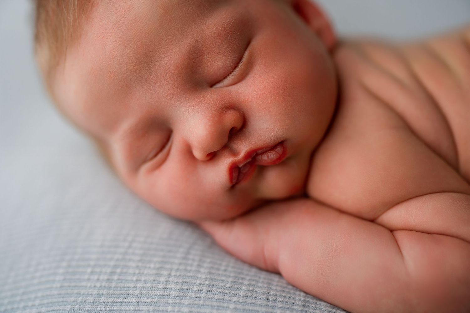 Peaceful sleeping newborn baby in soft natural light.