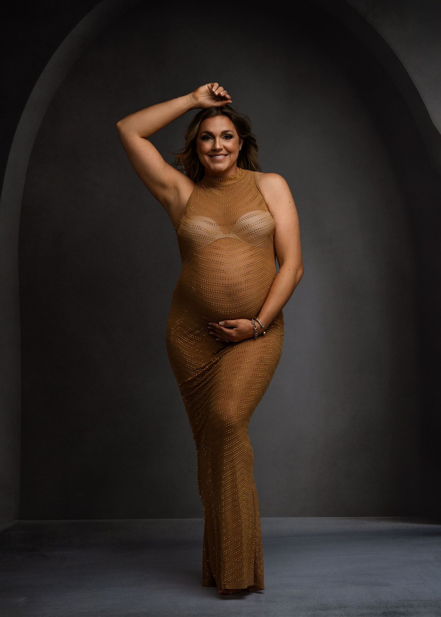 Artistic photo series showing graceful dance poses in a brown dress against dark backdrop.