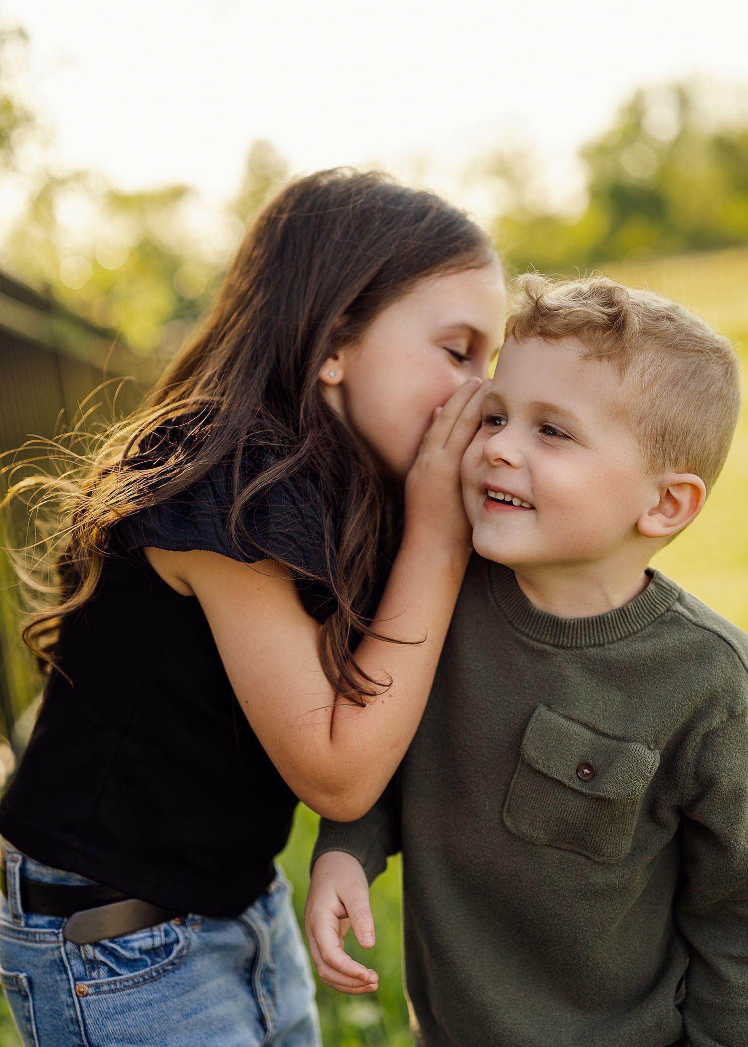 Sweet outdoor family moment captured in golden sunlight.